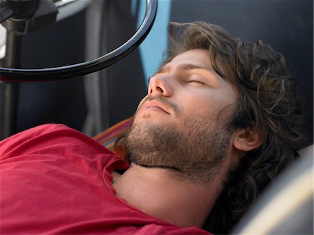 people lying down on the road - Young Man Sleeping in Vehicle, head and shoulders Stock Photo - Premium Royalty-Free, Code: 693-06019129