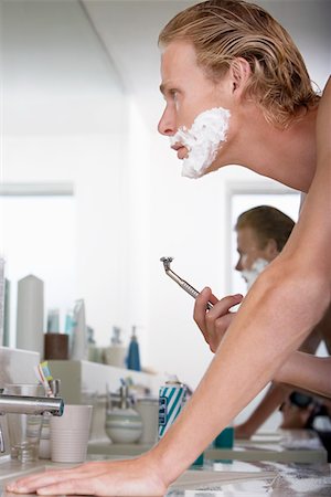 simsearch:693-07912164,k - Man shaving face in bathroom Stock Photo - Premium Royalty-Free, Code: 693-06019176