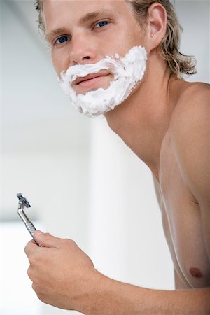simsearch:693-06019176,k - Man shaving face in bathroom, portrait Stock Photo - Premium Royalty-Free, Code: 693-06019177