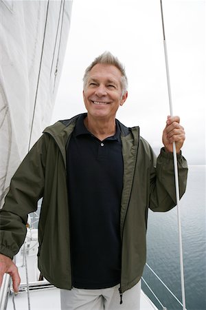 simsearch:693-06019372,k - Man standing on yacht, portrait Stock Photo - Premium Royalty-Free, Code: 693-06019370