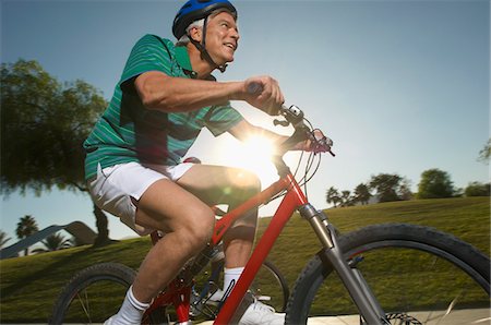 senior man bike - Senior man cycling in park at dusk Stock Photo - Premium Royalty-Free, Code: 693-06019407