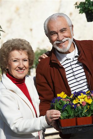 simsearch:693-06019332,k - Elderly man and senior woman holding tray with potted flowers Stock Photo - Premium Royalty-Free, Code: 693-06019440