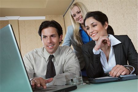 simsearch:693-03707355,k - Business man and woman using laptop at conference meeting Stock Photo - Premium Royalty-Free, Code: 693-06019628