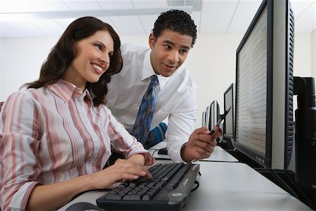 Man and woman using computer together Stock Photo - Premium Royalty-Free, Code: 693-06019706