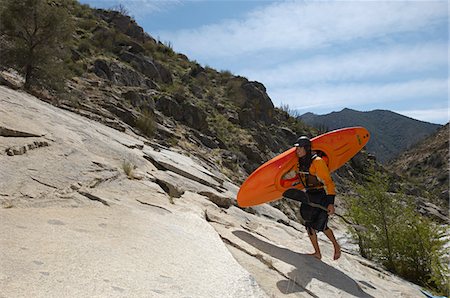 Female kayaker walking on rock, side view Stock Photo - Premium Royalty-Free, Code: 693-06019747