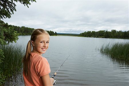 USA, Alaska, teenage girl fishing at lake, portrait Stock Photo - Premium Royalty-Free, Code: 693-06019761