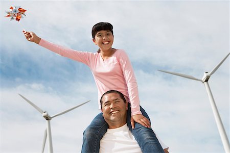 pin wheel family - Girl (7-9) sitting on fathers shoulders at wind farm, portrait Stock Photo - Premium Royalty-Free, Code: 693-06019782