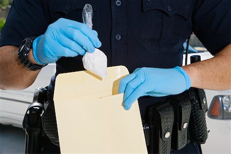 enforcement - Police Officer Putting Cocaine in Evidence Envelope Stock Photo - Premium Royalty-Free, Code: 693-06019840