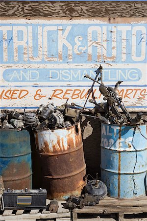 Rusty sign and barrels in junkyard Stock Photo - Premium Royalty-Free, Code: 693-06019870