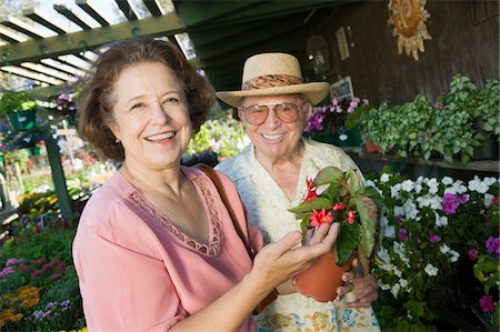 senior couple shopping outside - Senior Couple Shopping for flowers at plant nursery, portrait Stock Photo - Premium Royalty-Free, Code: 693-06013532