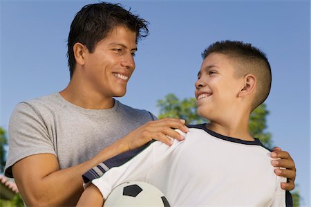 simsearch:693-06013621,k - Boy (13-15) holding soccer ball, with young man Stock Photo - Premium Royalty-Free, Code: 693-06013610