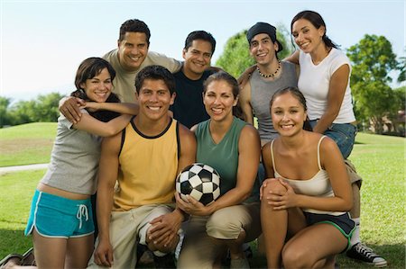 Group of people in park with woman holding soccer ball. Stock Photo - Premium Royalty-Free, Code: 693-06013624