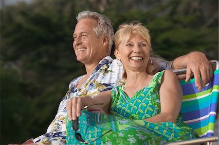 person in hawaiian shirt - Couple relaxing outdoors, smiling Stock Photo - Premium Royalty-Free, Code: 693-06013730