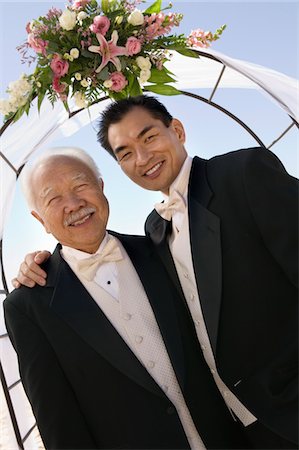 flower decoration in stage and marriage - Groom with father under archway, outdoors, (portrait) Stock Photo - Premium Royalty-Free, Code: 693-06013780