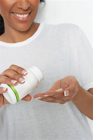 simsearch:693-06020009,k - Woman holding bottle of pills, close-up Stock Photo - Premium Royalty-Free, Code: 693-06020004