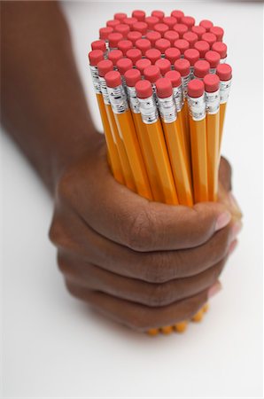 pencils and eraser - Person holding large group of pencils, close-up of hand Stock Photo - Premium Royalty-Free, Code: 693-06020376