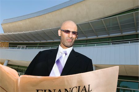 financial pages - Businessman Reading a Paper Stock Photo - Premium Royalty-Free, Code: 693-06020387