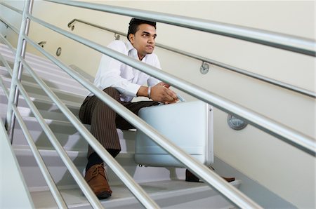 Businessman Sitting on a Stairway Foto de stock - Sin royalties Premium, Código: 693-06020397