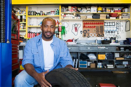 portrait guy in his garage - Auto Mechanic Working on a Tire Stock Photo - Premium Royalty-Free, Code: 693-06020529