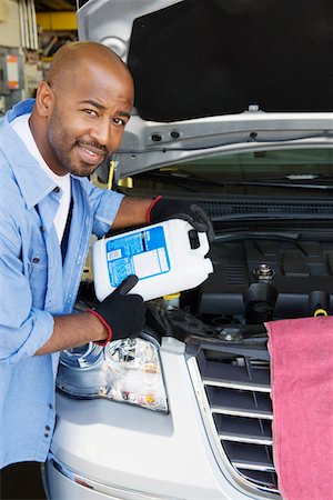 portrait guy in his garage - Auto Mechanic Adding Fluids to Minivan Stock Photo - Premium Royalty-Free, Code: 693-06020543