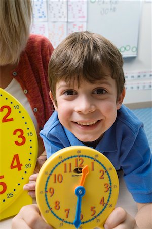 school room - Little Boy Learning to Tell Time Stock Photo - Premium Royalty-Free, Code: 693-06020579