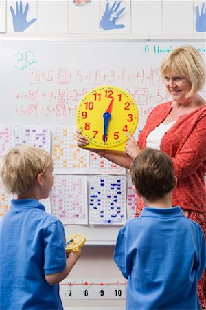 simsearch:693-06020699,k - Teacher Teaching Kids to Tell Time Stock Photo - Premium Royalty-Free, Code: 693-06020582