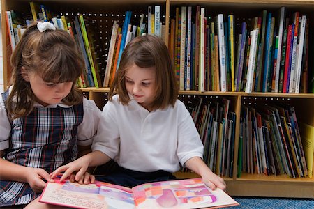 elementary school, outside - Little Girls Looking at a Picture Book Stock Photo - Premium Royalty-Free, Code: 693-06020597