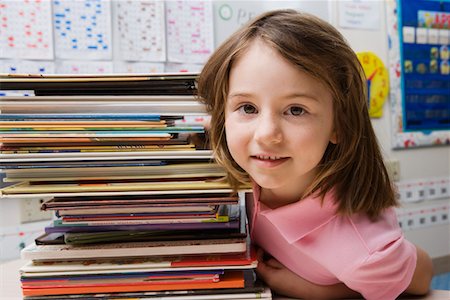 Little Girl with a Stack of Books Stock Photo - Premium Royalty-Free, Code: 693-06020657