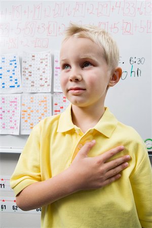 Schoolboy with His Hand over His Heart Stock Photo - Premium Royalty-Free, Code: 693-06020659