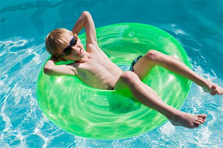 Boy on Float Tube in Swimming Pool Foto de stock - Sin royalties Premium, Código: 693-06020734