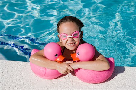 simsearch:693-06020819,k - Jeune fille au bord piscine détenant des canards en caoutchouc rose Photographie de stock - Premium Libres de Droits, Code: 693-06020764