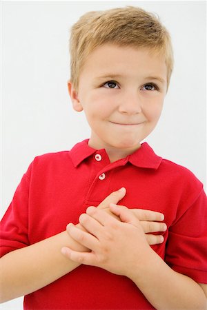 Boy with Hand Over Heart Foto de stock - Sin royalties Premium, Código: 693-06020821