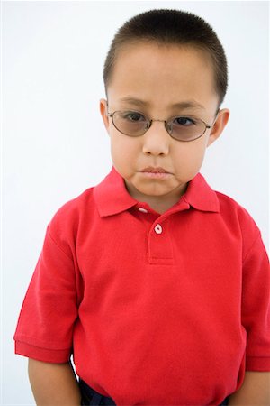 sulk boy - Young Boy Frowning Stock Photo - Premium Royalty-Free, Code: 693-06020845