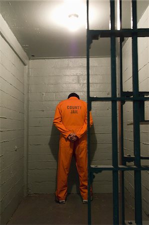 prison photograph - Prisoner standing against the wall Foto de stock - Sin royalties Premium, Código: 693-06020900