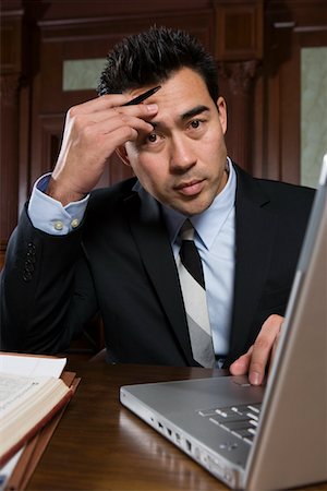 puzzled confused guy computer - Man using laptop in court, portrait Stock Photo - Premium Royalty-Free, Code: 693-06020982