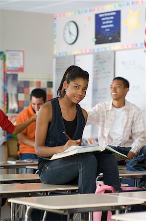 female teenagers students in a class - High School Student Sitting on a Desk in Class Stock Photo - Premium Royalty-Free, Code: 693-06021068