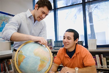 simsearch:693-06021167,k - High School Teacher Pointing out Location on Globe to Student Stock Photo - Premium Royalty-Free, Code: 693-06021148