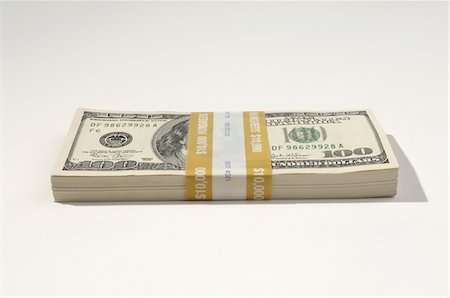 Stack of US Currency Stock Photo - Premium Royalty-Free, Code: 693-06021279