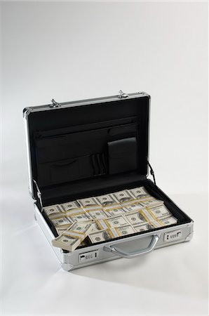 Briefcase Full of Money Stock Photo - Premium Royalty-Free, Code: 693-06021284