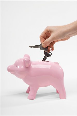 simsearch:693-06021323,k - Hand Putting Car Keys in Piggy Bank Foto de stock - Sin royalties Premium, Código: 693-06021339