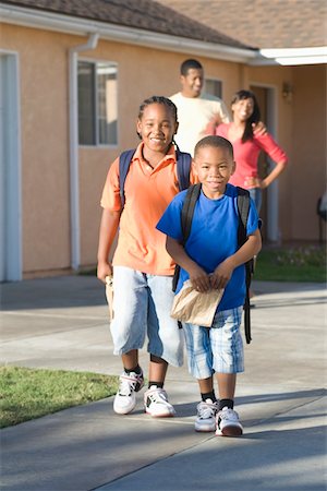 suburban family lifestyle - Parents watching children leave house Stock Photo - Premium Royalty-Free, Code: 693-06021447