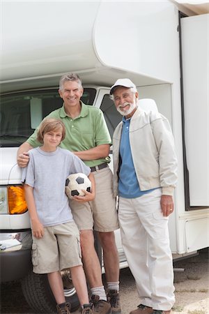 football father and sons - Father, son and grandson stand with RV home Stock Photo - Premium Royalty-Free, Code: 693-06021485