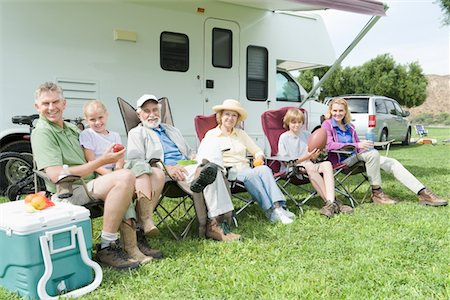 Family sitting outside RV home Stock Photo - Premium Royalty-Free, Code: 693-06021512