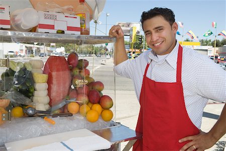 Portrait of male street vendor holding fruit salad Stock Photo - Premium Royalty-Free, Code: 693-06021531