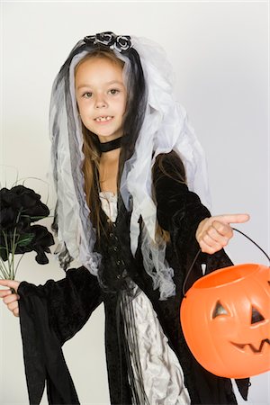 simsearch:693-06021611,k - Portrait of girl (7-9) wearing Halloween costume with jack-o-lantern Stock Photo - Premium Royalty-Free, Code: 693-06021614