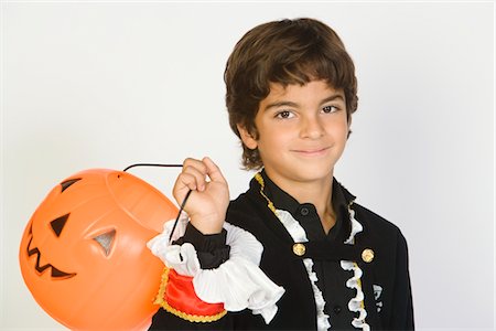 simsearch:693-06021611,k - Portrait of boy (7-9) wearing Halloween costume, with jack-o-lantern Stock Photo - Premium Royalty-Free, Code: 693-06021616