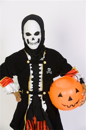 simsearch:693-06021611,k - Portrait of boy (7-9) wearing skeleton mask, with jack-o-lantern Stock Photo - Premium Royalty-Free, Code: 693-06021618