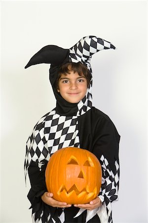 simsearch:693-06021611,k - Portrait of boy (7-9) wearing jester costume, with jack-o-lantern Stock Photo - Premium Royalty-Free, Code: 693-06021629
