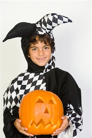 simsearch:693-06021611,k - Portrait of boy (7-9) wearing jester costume, with jack-o-lantern Stock Photo - Premium Royalty-Free, Code: 693-06021630