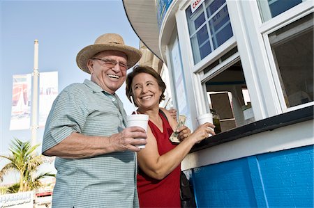 Senior couple buying drinks at food stand Stock Photo - Premium Royalty-Free, Code: 693-06021657